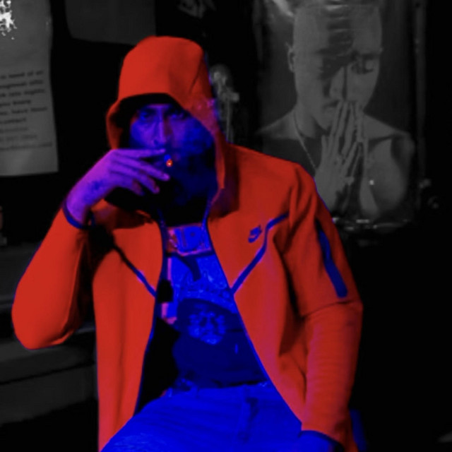 Dicey Ray in a red hoodie, official Spotify artist portrait